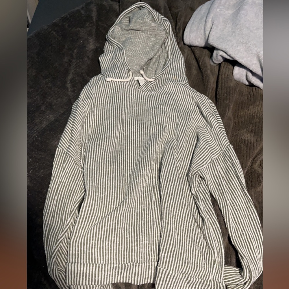 Green striped shirt with pockets and hood.